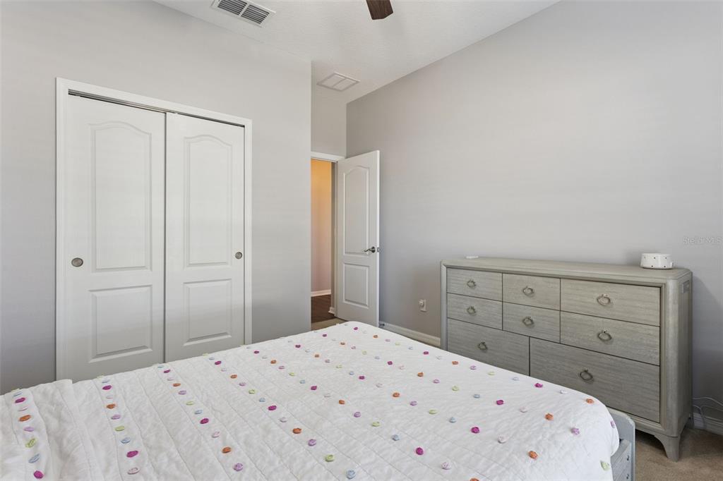 2400 Artist Point Court Apopka, FL 32703 - Photo 21 of 50 a bedroom with a bed and a dresser