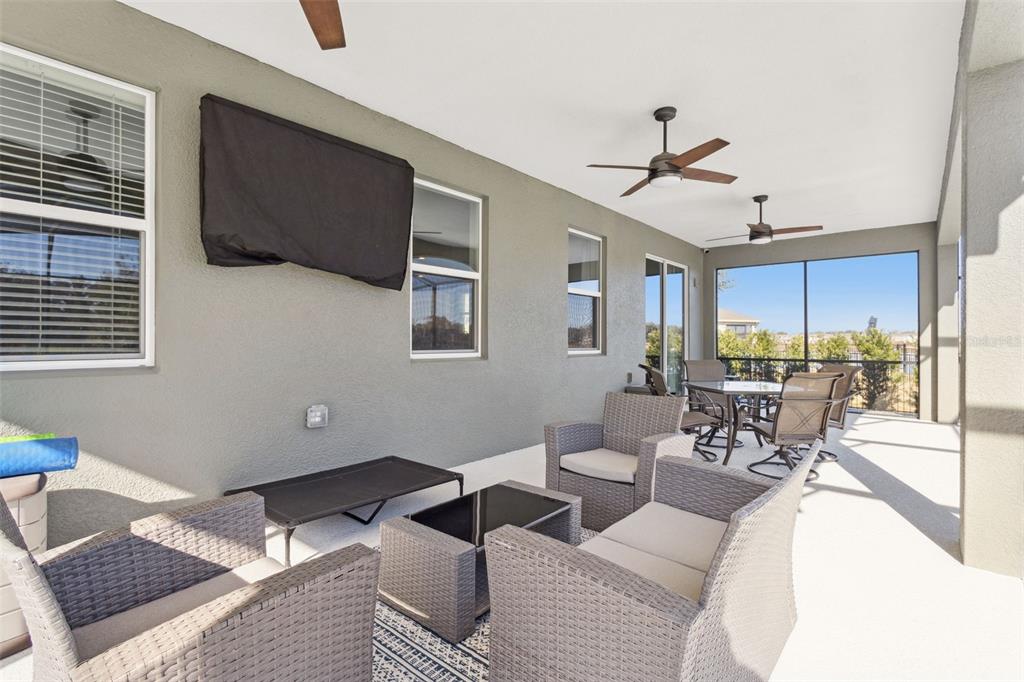 2400 Artist Point Court Apopka, FL 32703 - Photo 27 of 50 a living room with furniture a flat screen tv and kitchen view