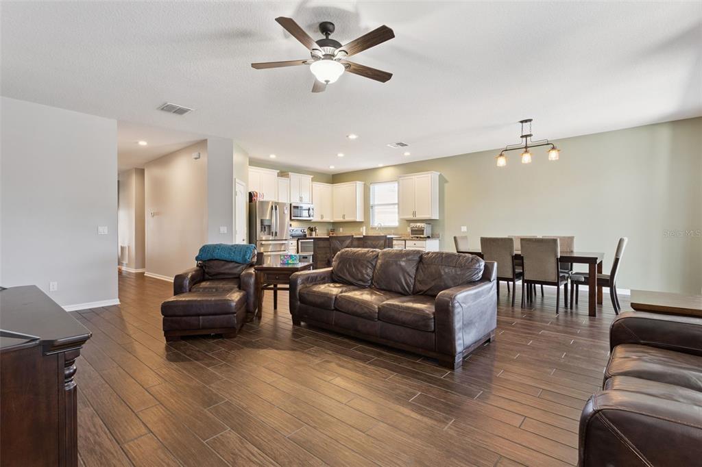 2400 Artist Point Court Apopka, FL 32703 - Photo 5 of 50 a living room with furniture and wooden floor