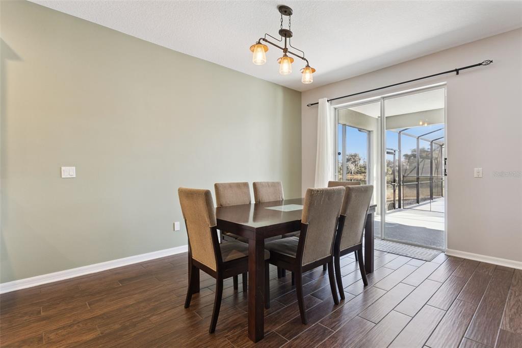 2400 Artist Point Court Apopka, FL 32703 - Photo 9 of 50 a view of a dining room with furniture window and wooden floor