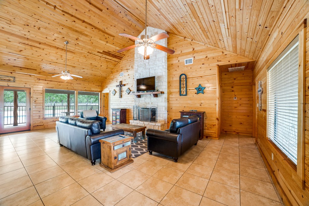 170 Johhny Seibert Lane Rio Frio, TX 78879 - Photo 29 of 67 a living room with fireplace furniture and a large window
