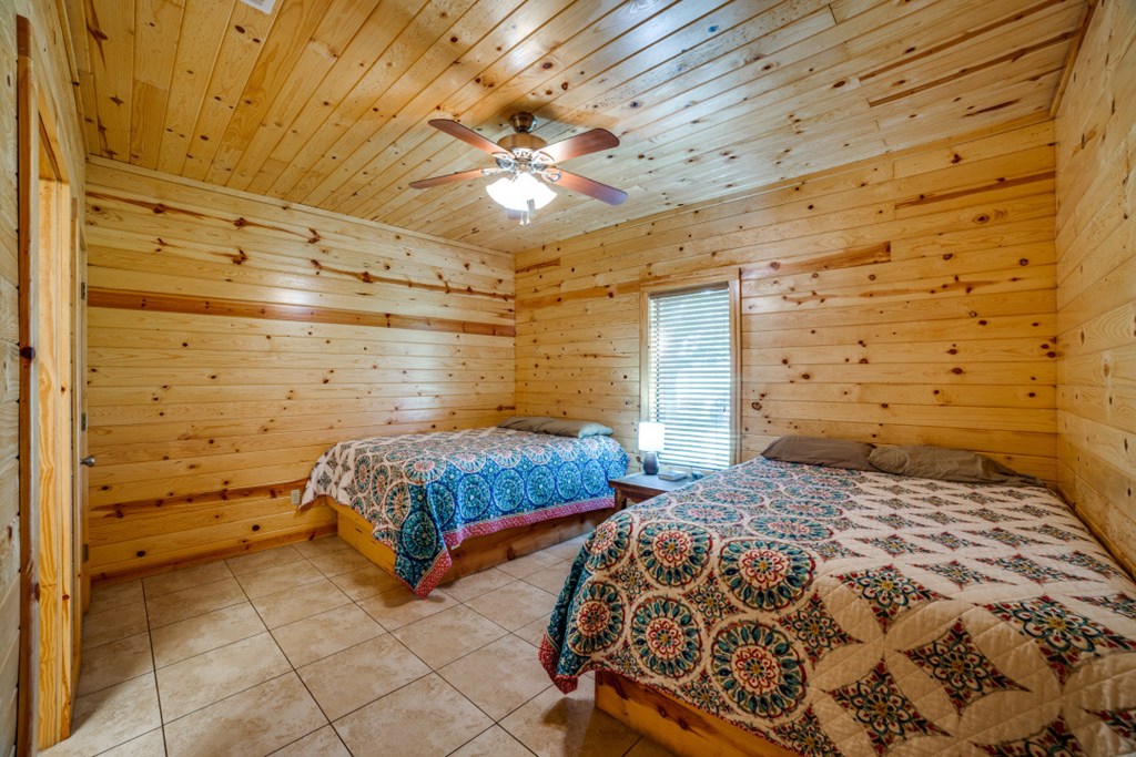 170 Johhny Seibert Lane Rio Frio, TX 78879 - Photo 7 of 67 a bedroom with a bed and a chandelier