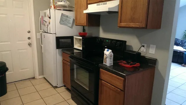 a kitchen with stainless steel appliances granite countertop a stove and a refrigerator