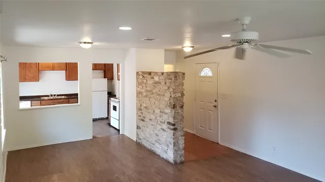 a view of a livingroom with a hardwood floor and a ceiling fan