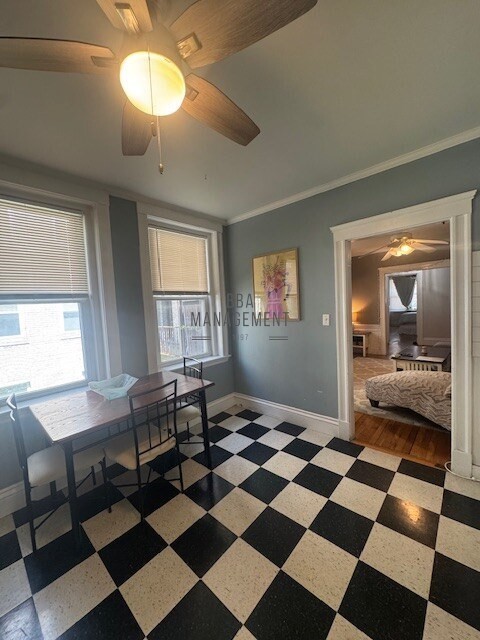 30 Chiswick Road, Unit 5 Boston, MA 02135 - Photo 2 of 12 a room with a black white checkered floor with a gaming machine and dining chair