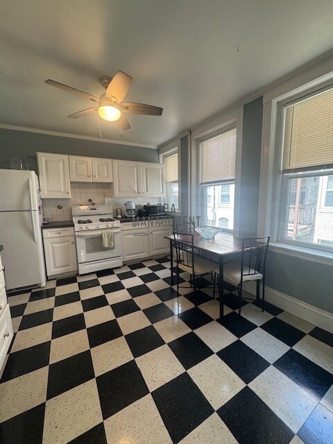 30 Chiswick Road, Unit 5 Boston, MA 02135 - Photo 4 of 12 a kitchen with a black white checkered floor and a black white checkered floor
