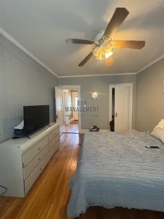 a bed room with a bed and a chandelier