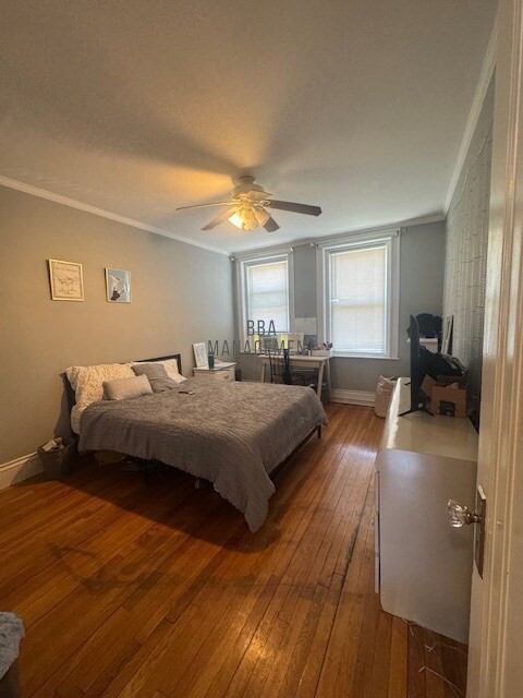 30 Chiswick Road, Unit 5 Boston, MA 02135 - Photo 10 of 12 a bedroom with a bed and wooden floor