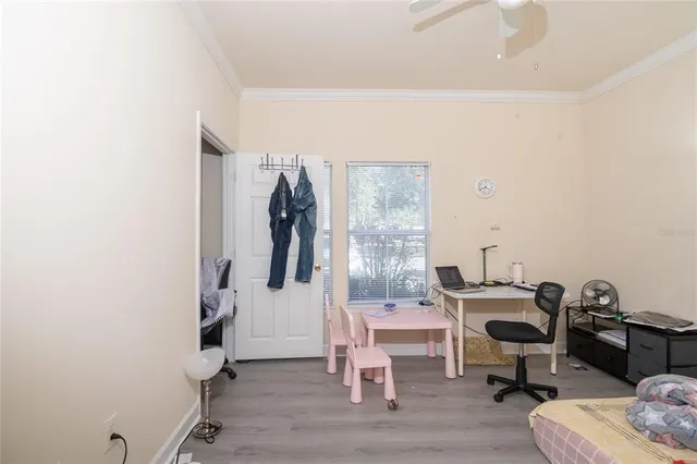 a view of a workspace with furniture and a window