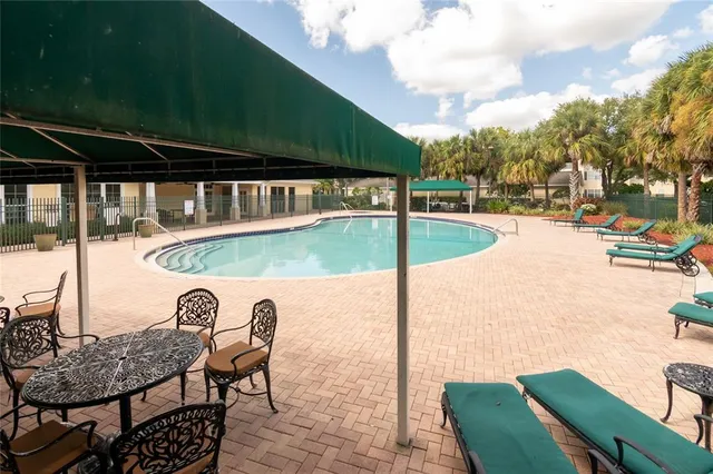 a view of yard from deck with patio