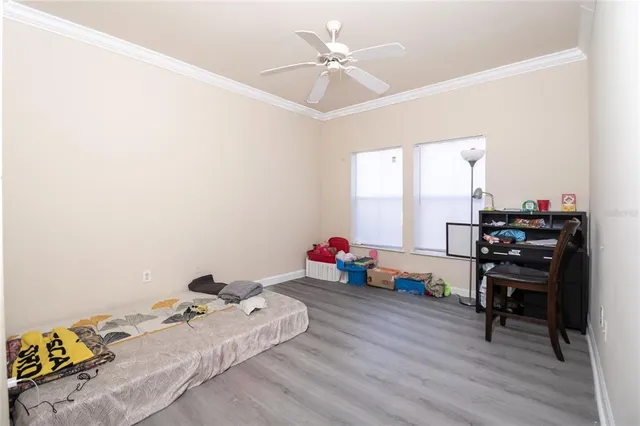 a bedroom with furniture and a wooden floor