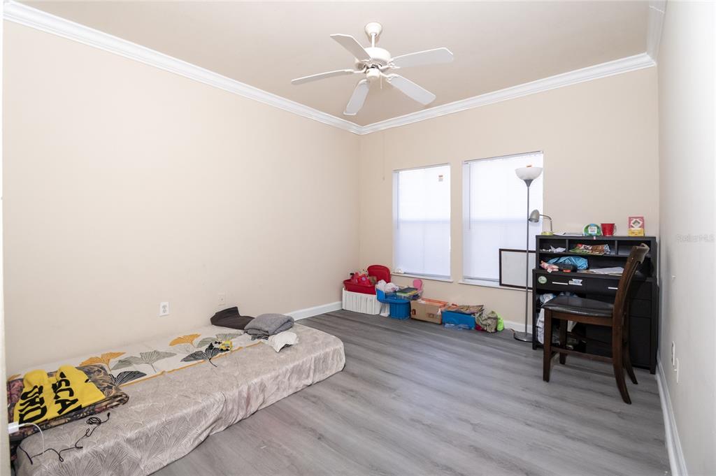 18103 Back Stretch Lane Tampa, FL 33647 - Photo 8 of 24 a bedroom with furniture and a wooden floor