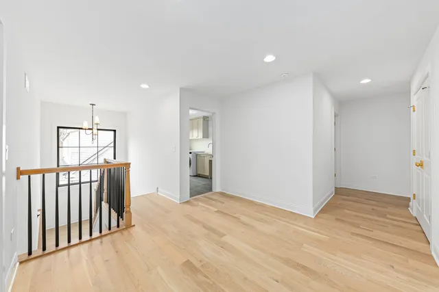 a view of a bedroom with wooden floor