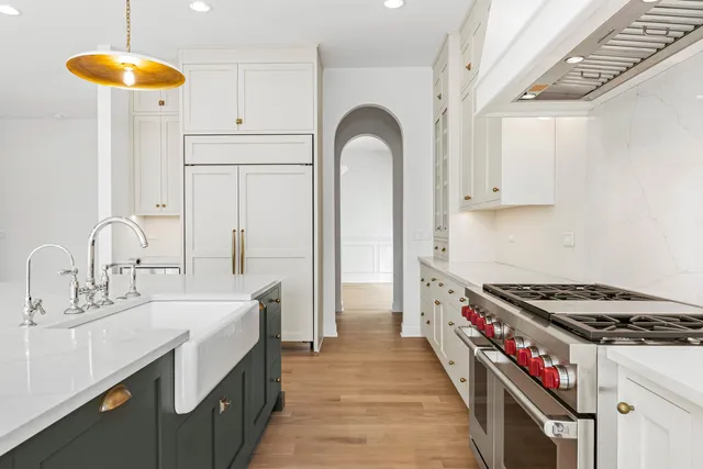 a kitchen with sink a stove and cabinets