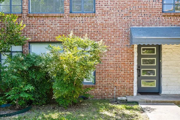 a view of a house with a yard and a tree