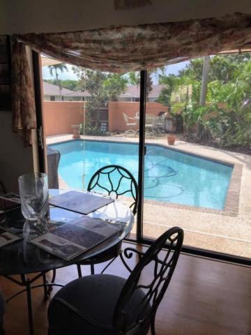 22701 Bella Rita Circle Boca Raton, FL 33433 - Photo 23 of 24 a view of a porch with furniture and a yard