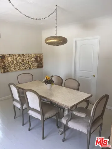 a view of a room with furniture and chandelier