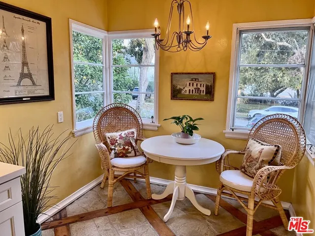 a view of a dining room with furniture wooden floor and a chandelier