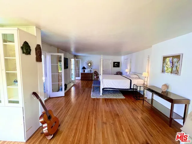a bedroom with furniture and a wooden floor