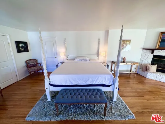 a bed sitting in a bedroom and table