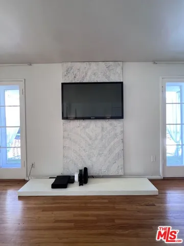 a living room with a flat screen tv and a fireplace