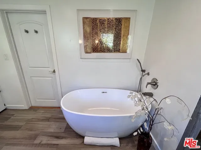 a spacious bathroom with a bathtub and shower