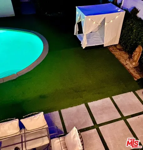 a view of an house with swimming pool and yard