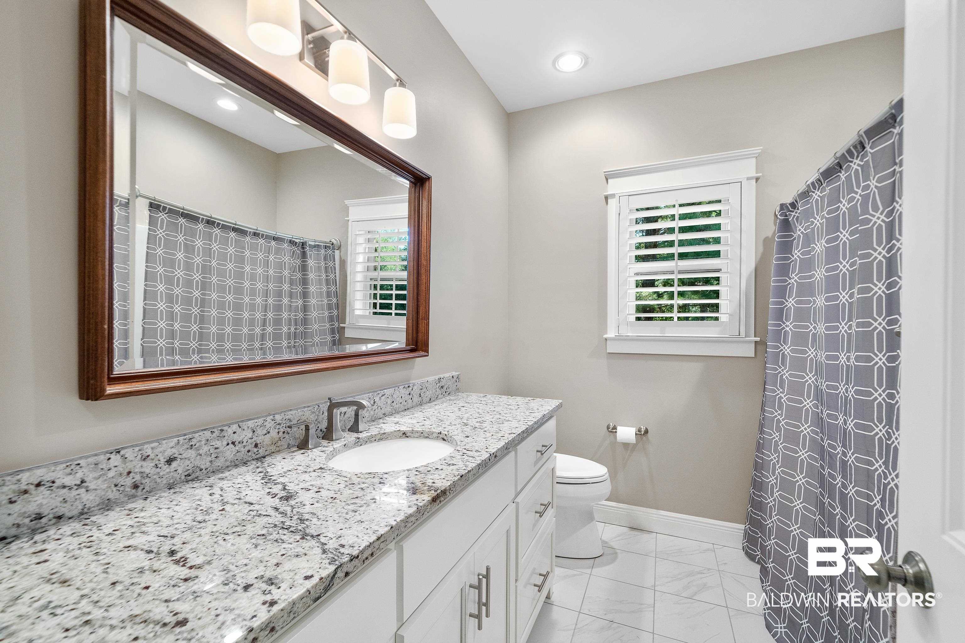29530 St John Street Daphne, AL 36526 - Photo 13 of 38 Bathroom with a shower with curtain, vanity, and toilet