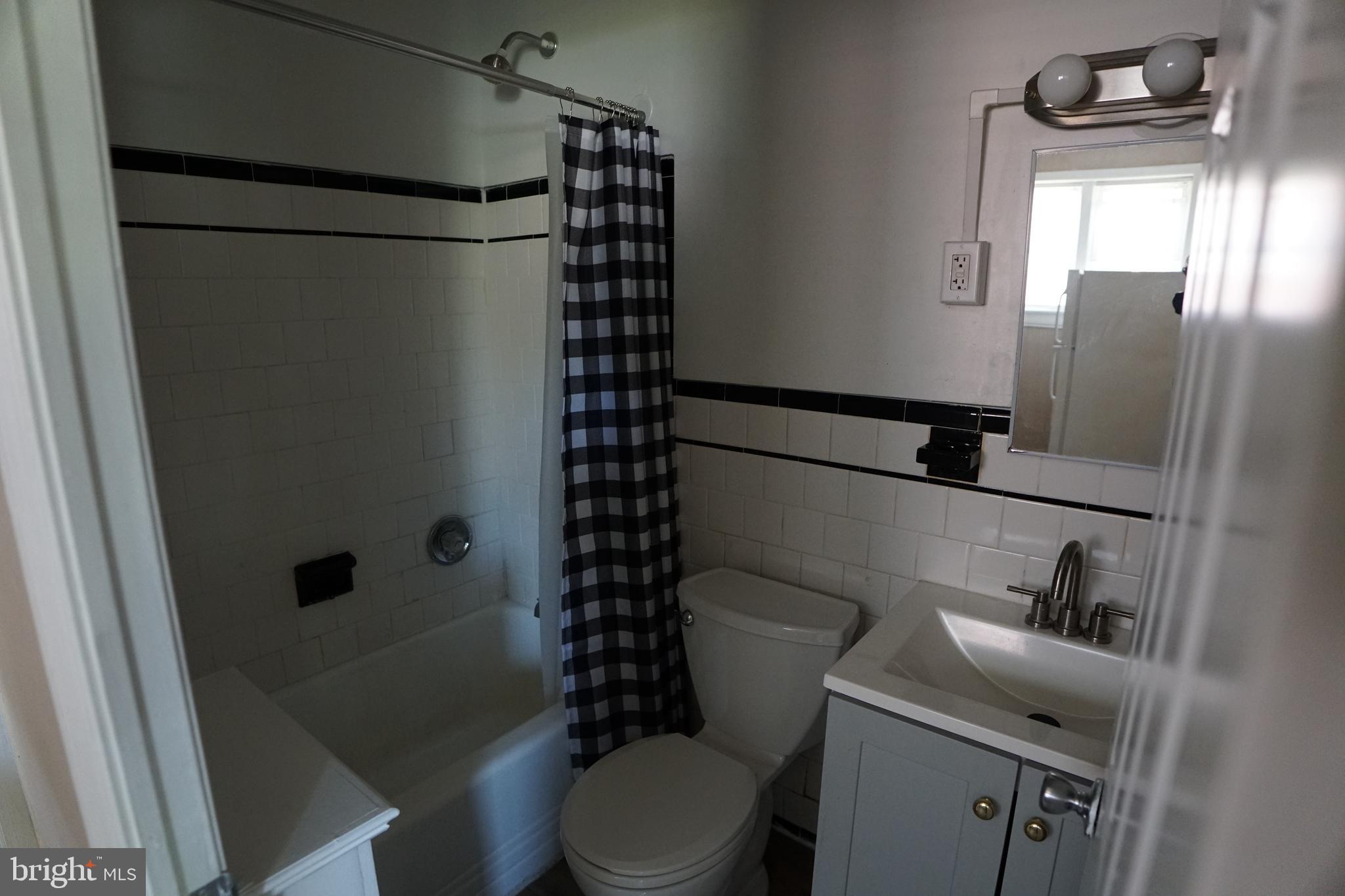 2 Aigburth Road, Unit 1 Towson, MD 21286 - Photo 6 of 10 a bathroom with a toilet and a shower curtain