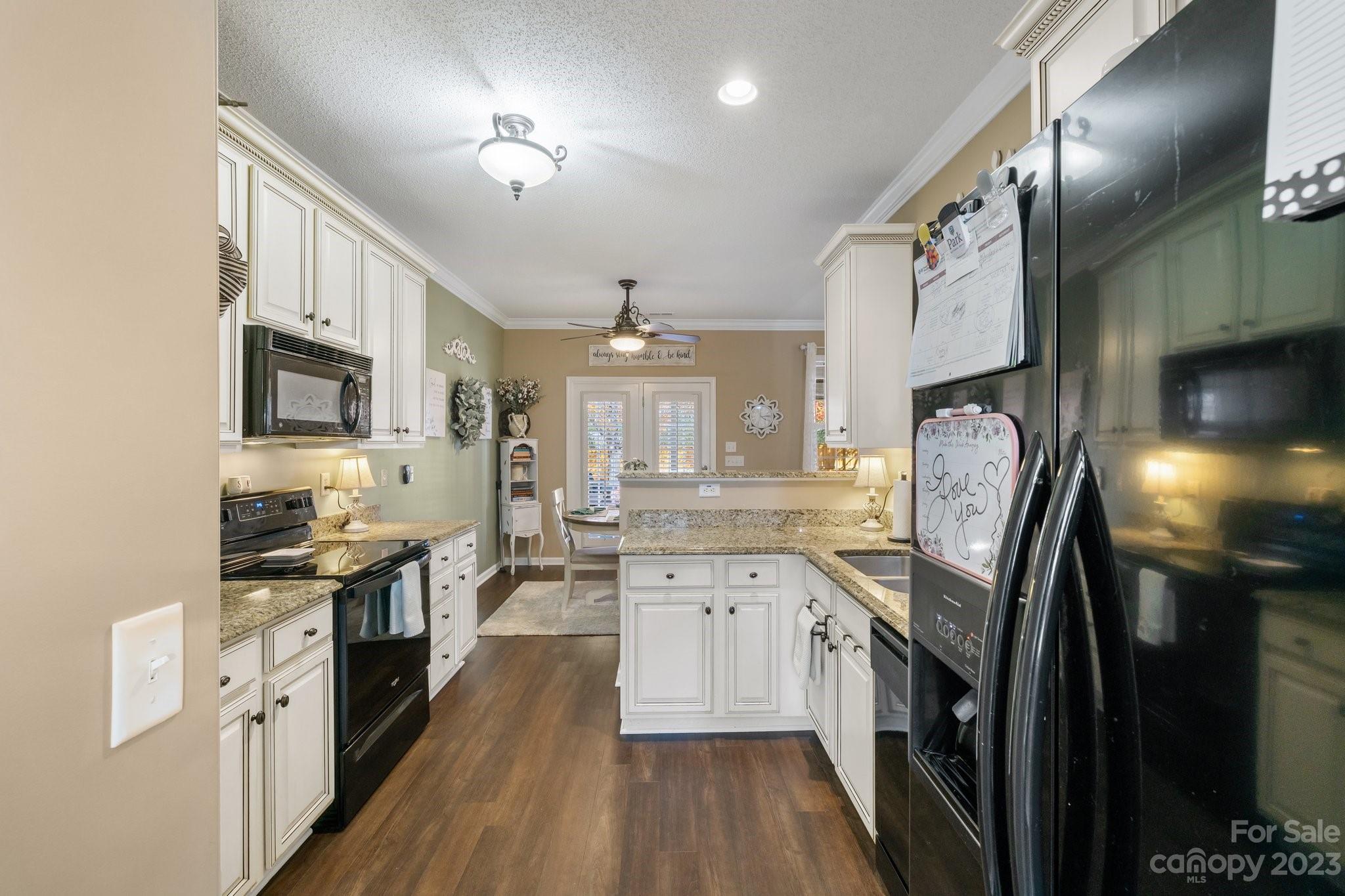 101 Woodfern Road Fletcher, NC 28732 - Photo 11 of 38 a kitchen with stainless steel appliances granite countertop lots of counter top space a refrigerator a stove a sink and a microwave
