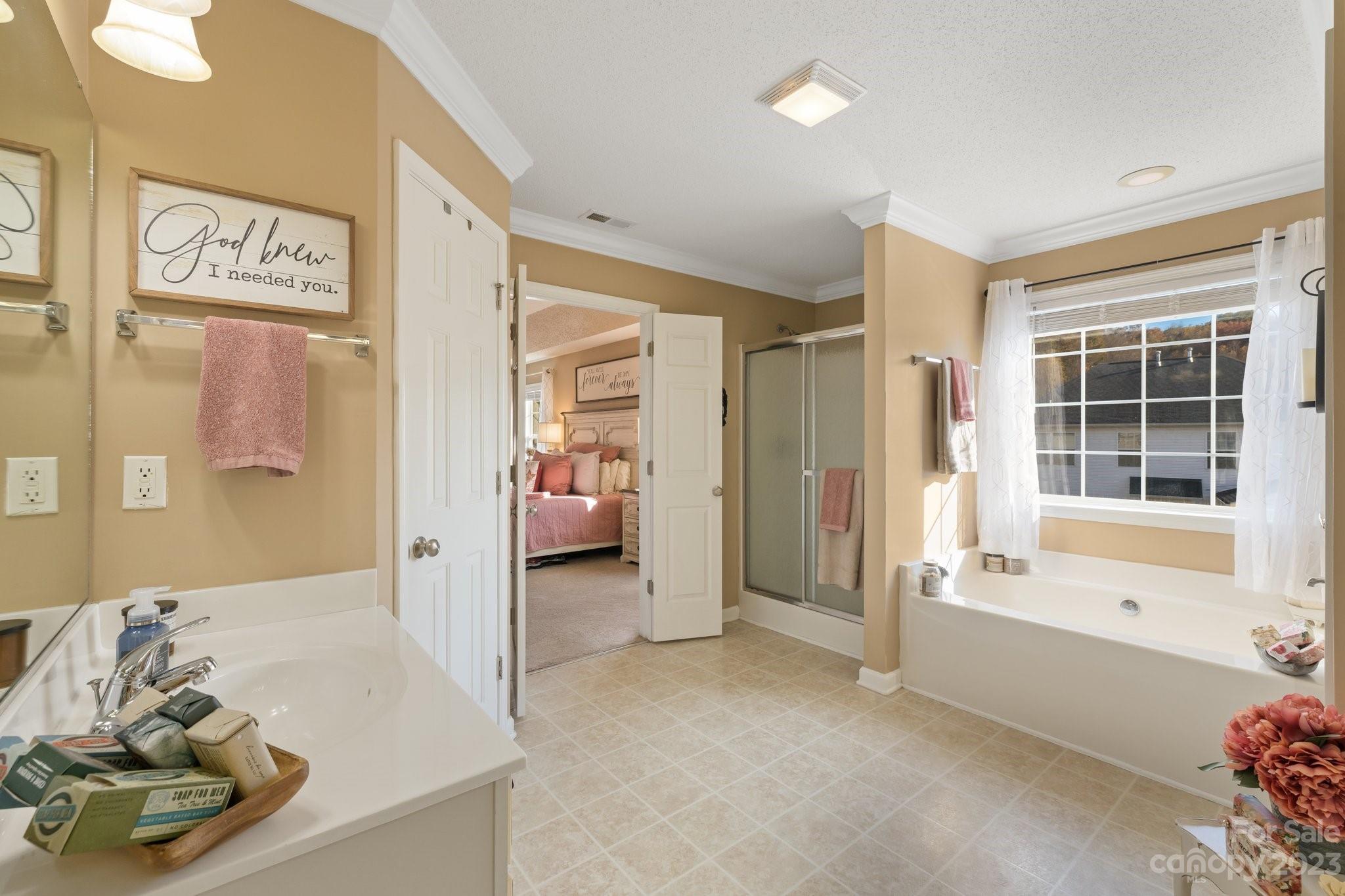 101 Woodfern Road Fletcher, NC 28732 - Photo 31 of 38 a spacious bedroom with a bed and a couch