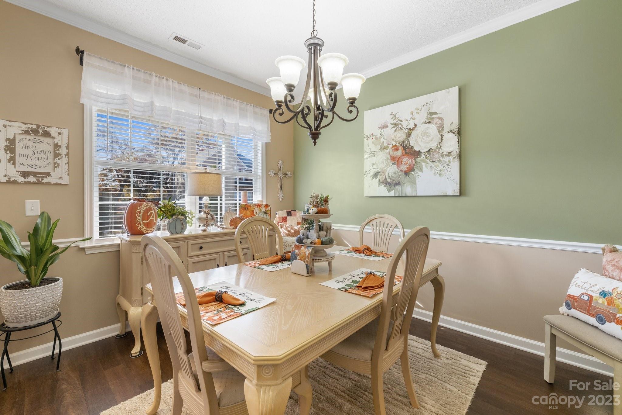 101 Woodfern Road Fletcher, NC 28732 - Photo 6 of 38 a view of a dining room with furniture wooden floor and a chandelier