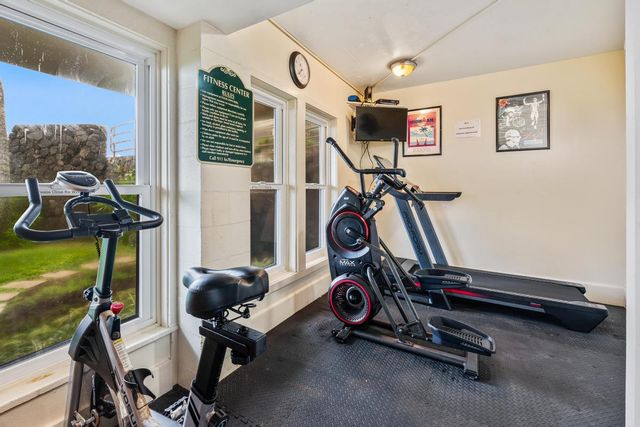 front view of a house with a small yard and potted plants