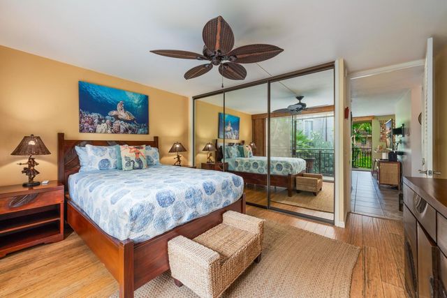 a bedroom with a large bed and a chandelier