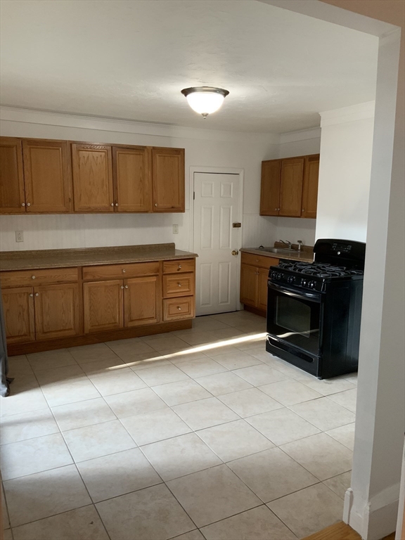 27 Jenkins Street Boston, MA 02127 - Photo 14 of 23 a kitchen with stainless steel appliances granite countertop a sink and a cabinets