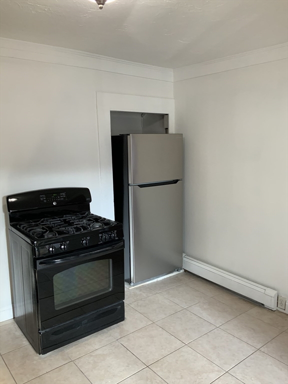 27 Jenkins Street Boston, MA 02127 - Photo 15 of 23 a kitchen with a stove and a refrigerator