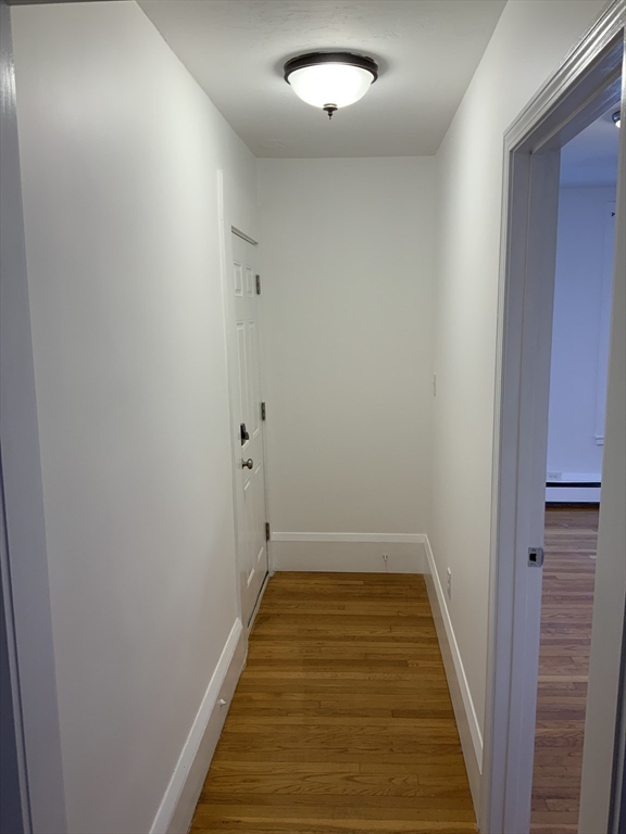 27 Jenkins Street Boston, MA 02127 - Photo 16 of 23 a view of hallway with wooden floor