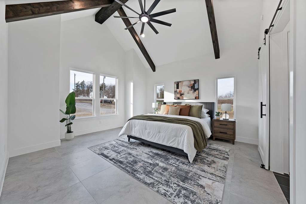 3089 County Road 1076 Celeste, TX 75423 - Photo 23 of 39 a spacious bedroom with a bed and a window