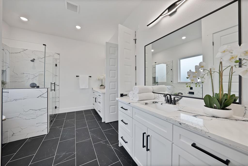 3089 County Road 1076 Celeste, TX 75423 - Photo 25 of 39 a spacious bathroom with a double vanity sink a mirror and a shower