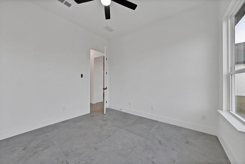 3089 County Road 1076 Celeste, TX 75423 - Photo 29 of 39 an empty room with a window and a ceiling fan