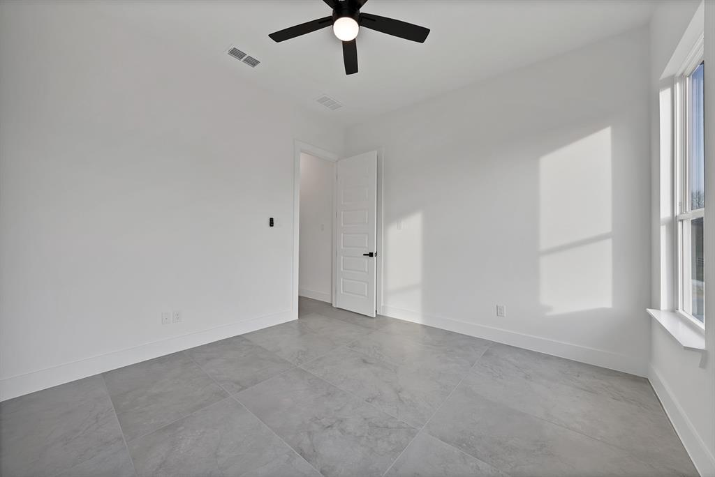 3089 County Road 1076 Celeste, TX 75423 - Photo 31 of 39 an empty room with windows and fan