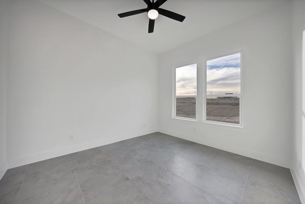 3089 County Road 1076 Celeste, TX 75423 - Photo 33 of 39 an empty room with window and ceiling fan