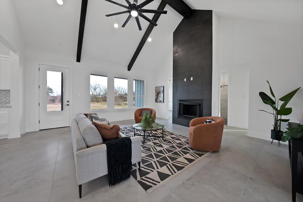 3089 County Road 1076 Celeste, TX 75423 - Photo 7 of 39 a living room with furniture a fireplace and a potted plant