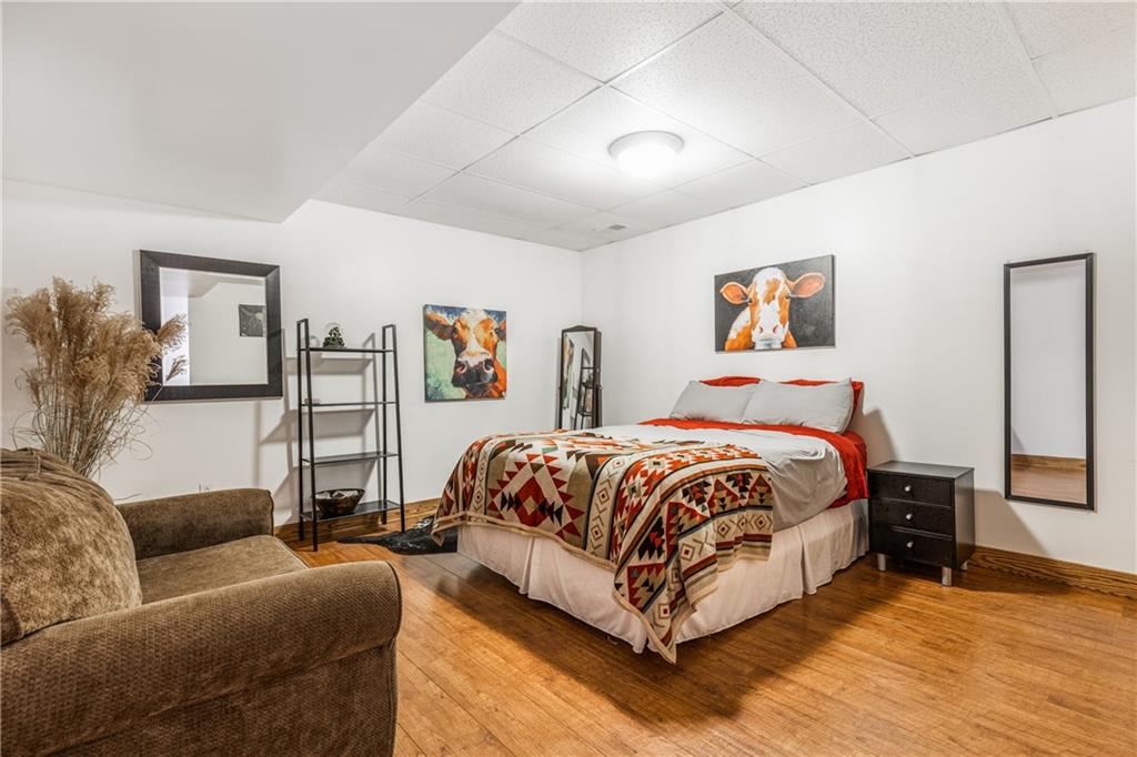 298 Laird's Crossing Road Worthington, PA 16262 - Photo 18 of 25 a spacious bedroom with a bed a couch and a flat screen tv