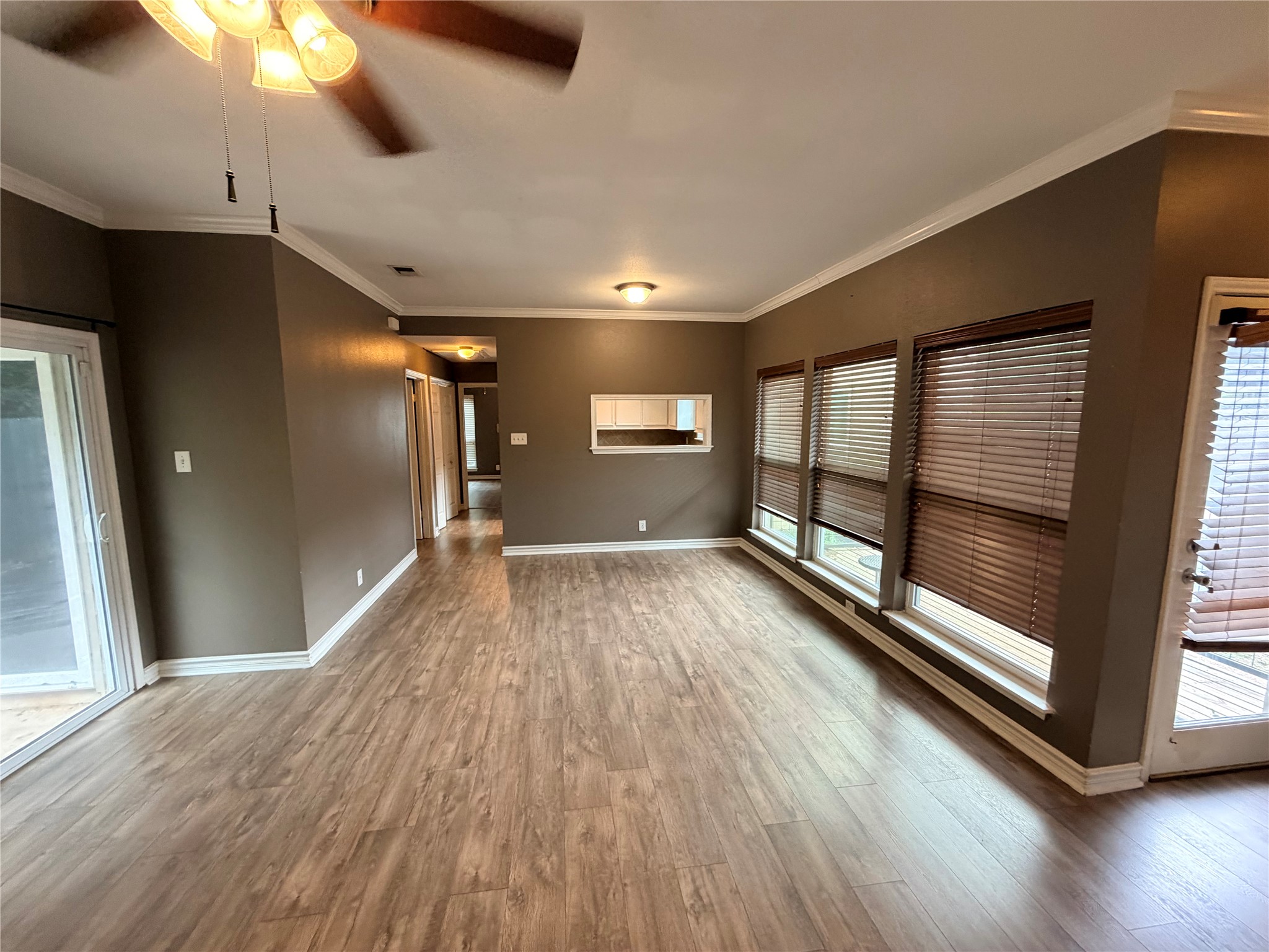 6600 Valleyside Road, Unit D20 Austin, TX 78731 - Photo 14 of 14 An inviting interior space features wood-style flooring and abundant natural illumination through multiple windows.