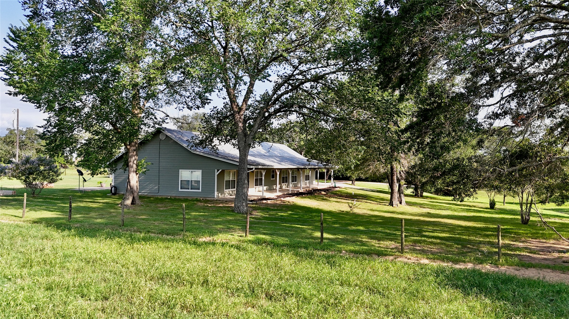 3545 East I- 10 Frontage Road Schulenburg, TX 78956 - Photo 38 of 40 a house with a big yard and large trees