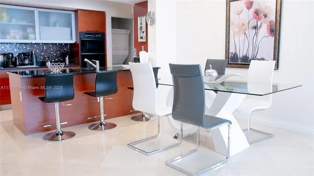 a dining room with table and chairs