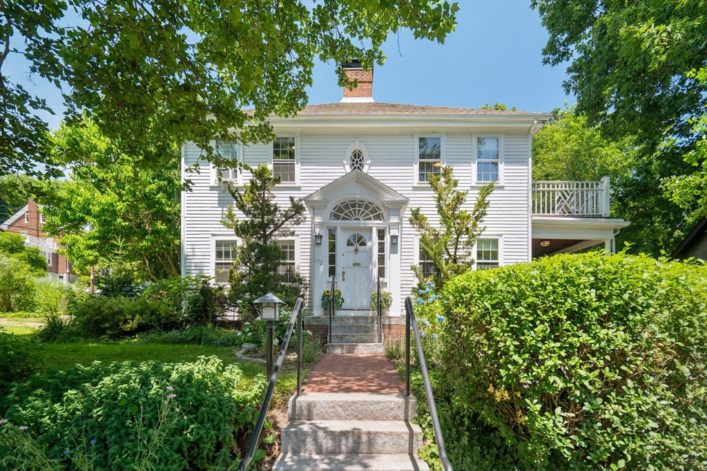 a front view of a house with garden