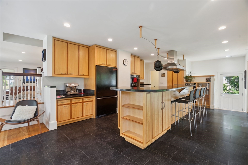 172 Bellevue Road Watertown, MA 02472 - Photo 11 of 34 a kitchen with granite countertop a table chairs refrigerator and a sink