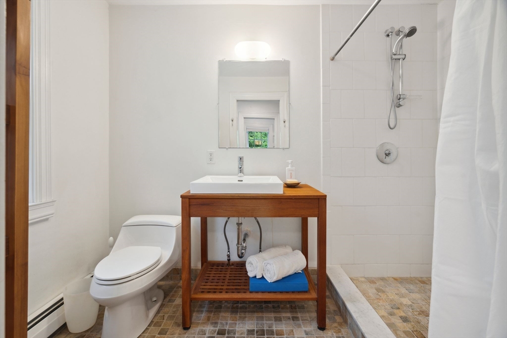 172 Bellevue Road Watertown, MA 02472 - Photo 19 of 34 a bathroom with a toilet a sink and mirror